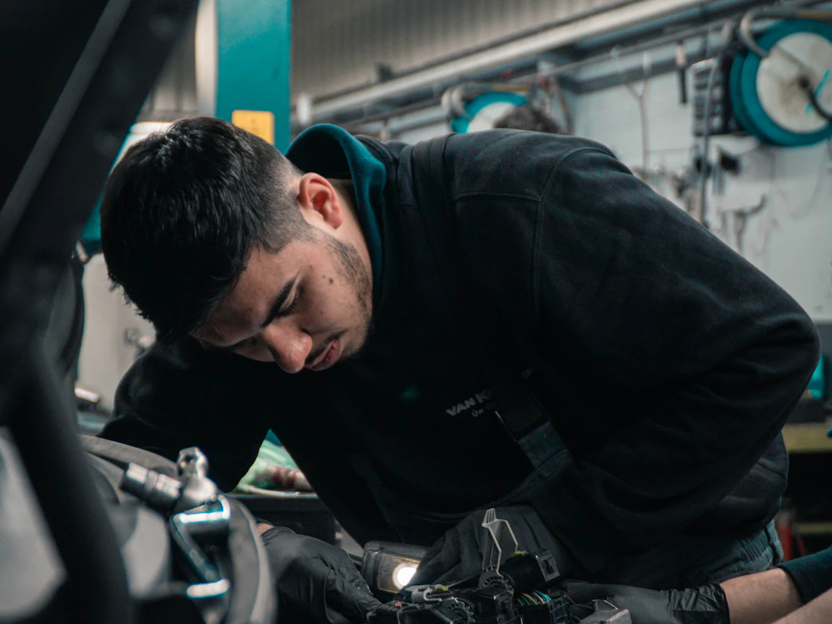Mechanic at work in a garage, Alori app for auto repair