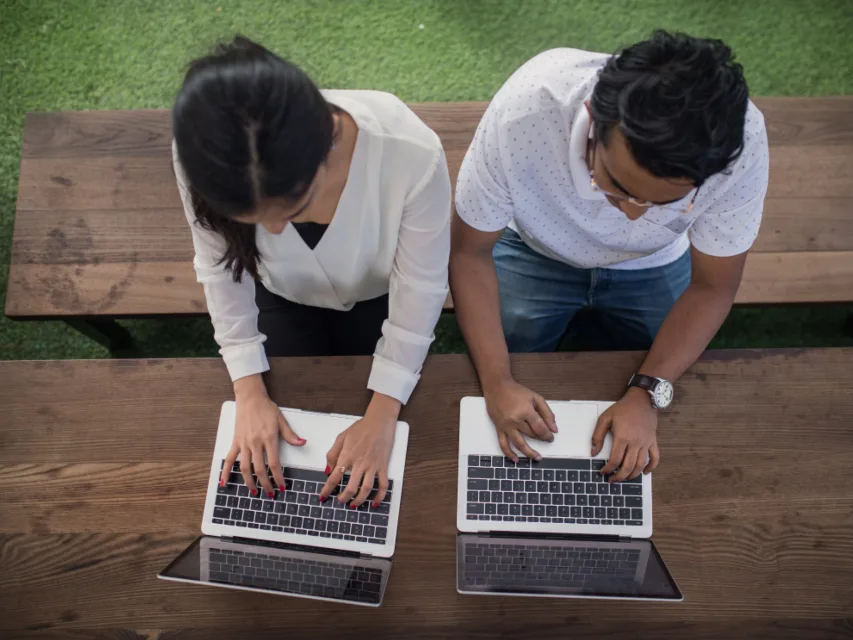 Two people working on laptops, Alori app for software companies