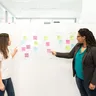 Team planning on a wall of sticky notes, Alori app for agencies