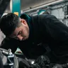 Mechanic at work in a garage, Alori app for auto repair
