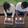 Two people working on laptops, Alori app for software companies