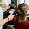 Stylist at work in a salon, Alori app for salons